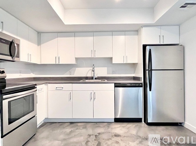 A kitchen with white cabinets and stainless steel appliances.