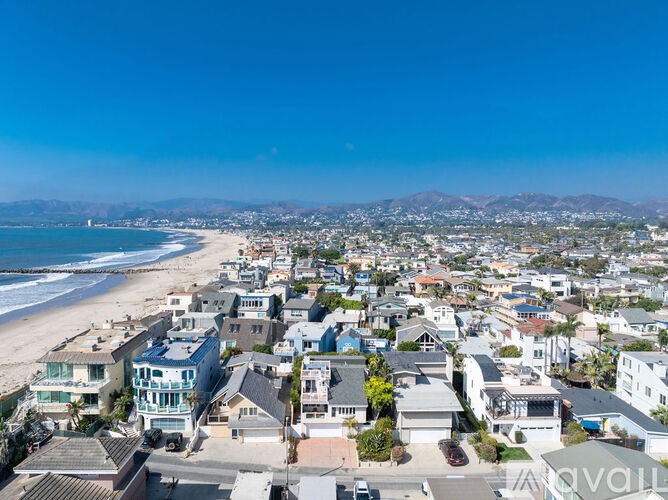 A beachfront neighborhood with a clear blue sky overhead.