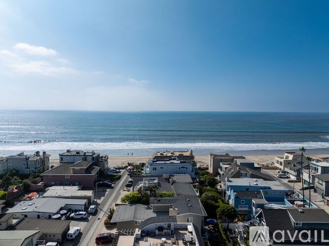 A beachfront community with houses and a clear blue sky.