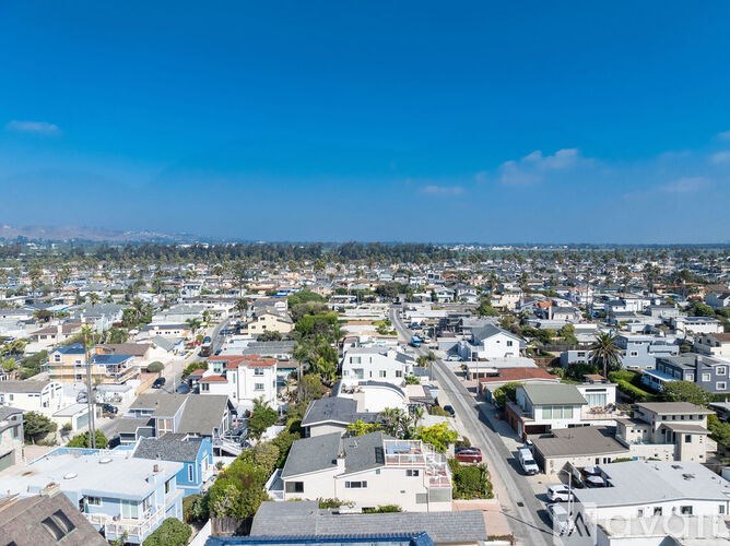 A clear day in a residential area with houses and streets.