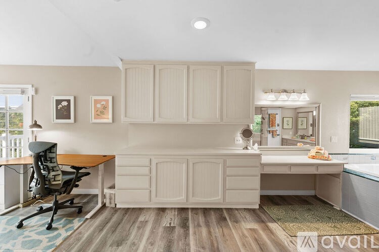 A room with a desk and a chair in it.