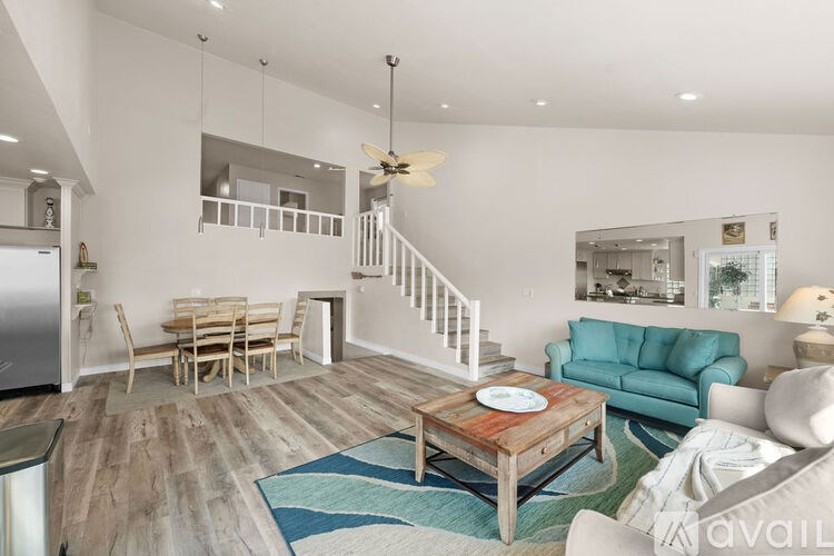 A living room with a wooden coffee table and a blue couch.
