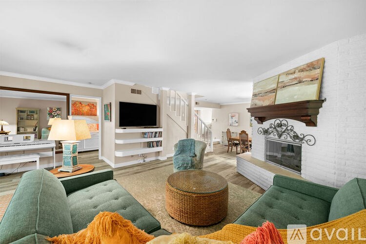 A living room with a green couch and a television.