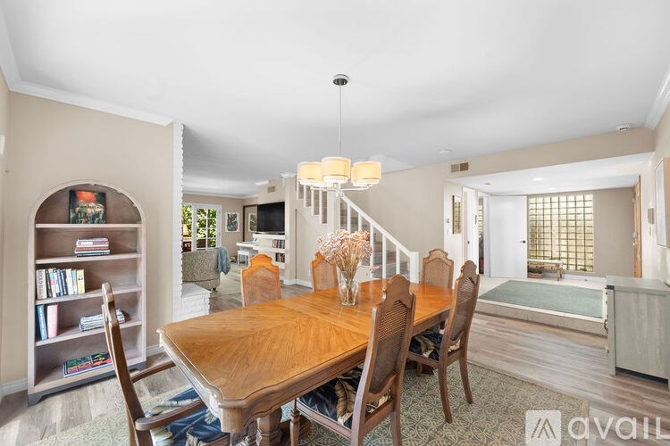A dining room with a wooden table and chairs.