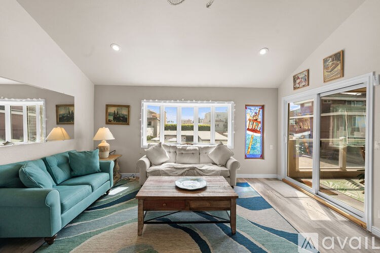 A living room with a blue couch and a coffee table.