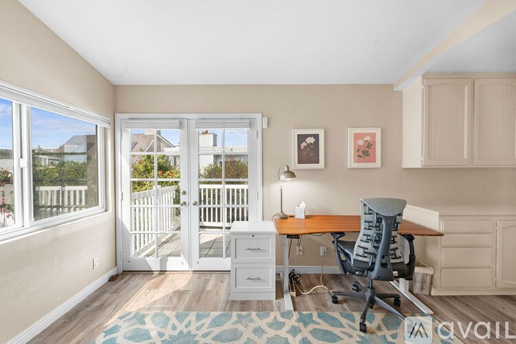 A room with a desk and a chair in it.