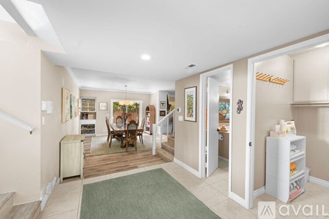 A living room with a dining table and chairs.