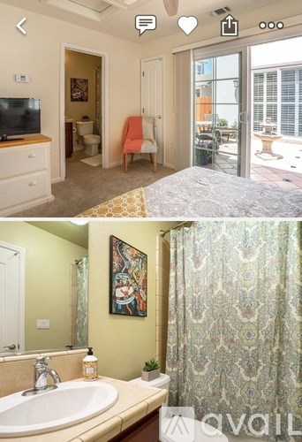 A bathroom with a sink, mirror, and shower curtain.