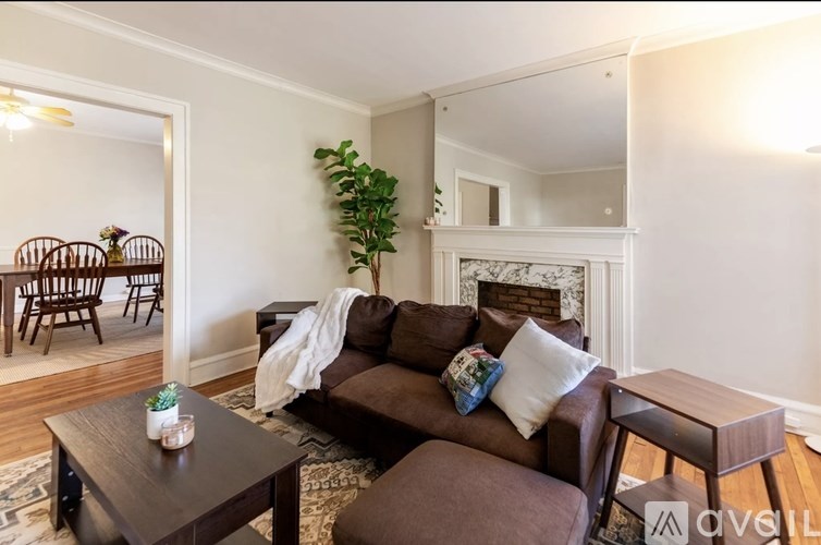 A living room with a brown couch and a coffee table.