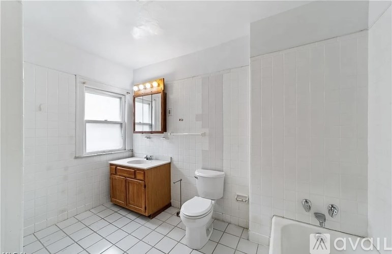 A bathroom with a toilet, sink, and bathtub.