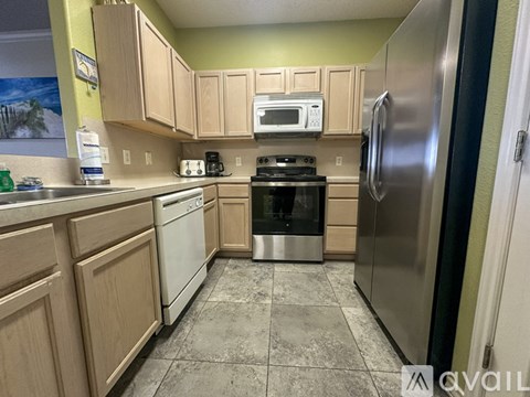 A kitchen with wooden cabinets and stainless steel appliances.