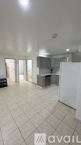 A kitchen with wooden floors and stainless steel appliances.