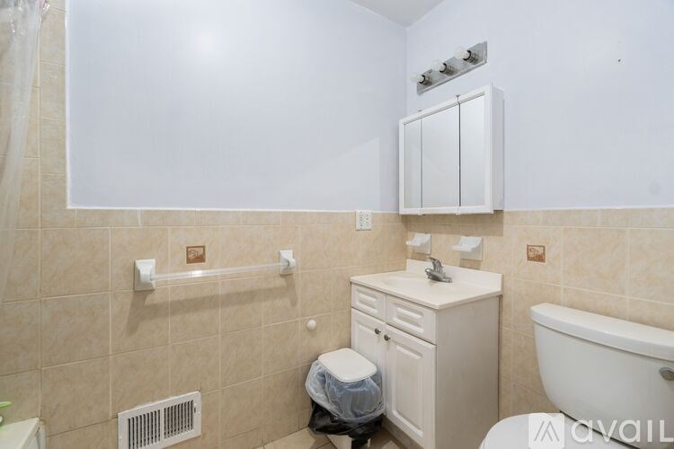 A bathroom with a toilet, sink, and bathtub.