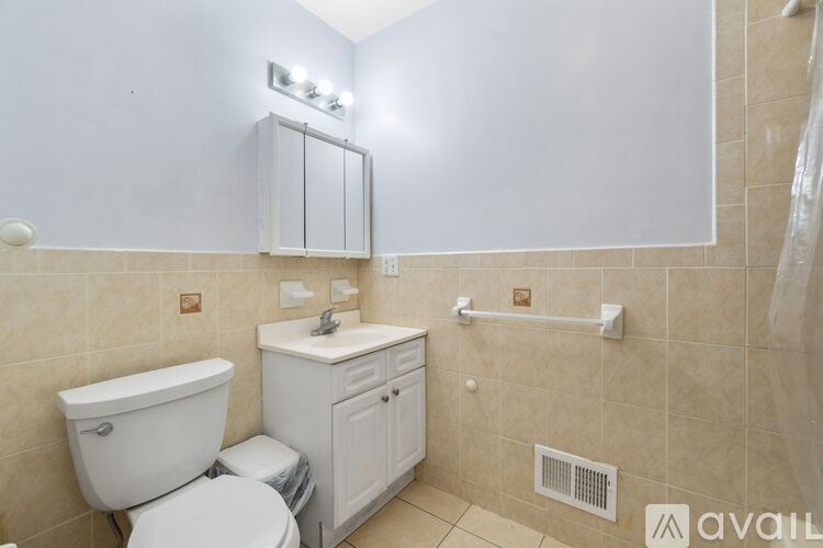 A bathroom with a toilet, sink, and bathtub.