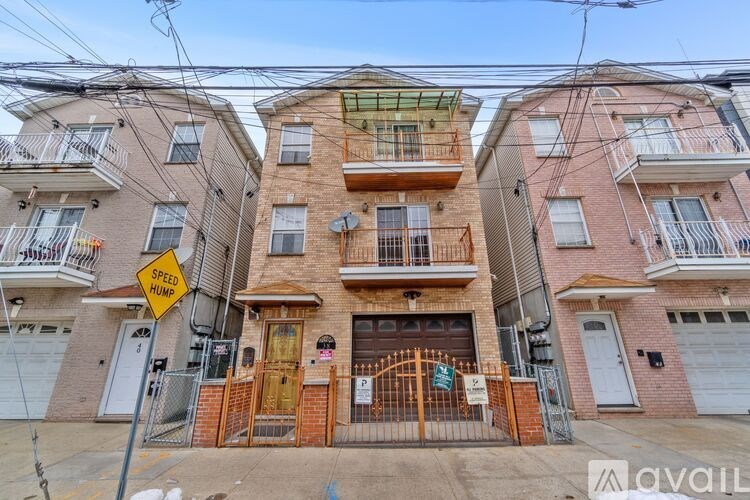 A street view of a residential area with apartment buildings and a speed hump sign.