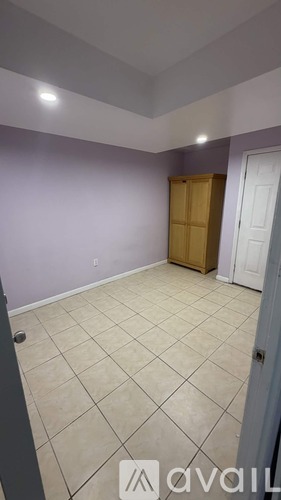 A kitchen with wooden floors and white walls.
