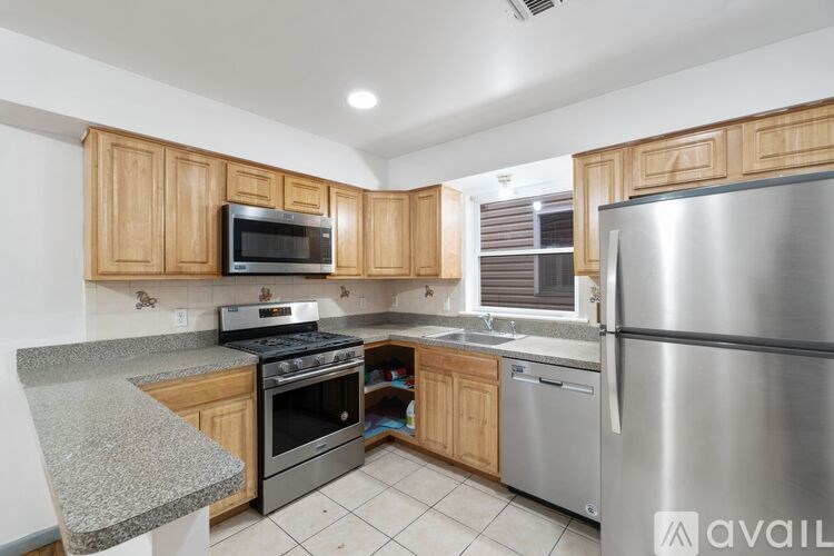 A kitchen with wooden cabinets and stainless steel appliances.