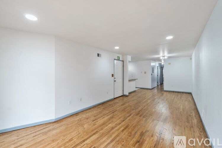 A room with wooden floors and white walls.