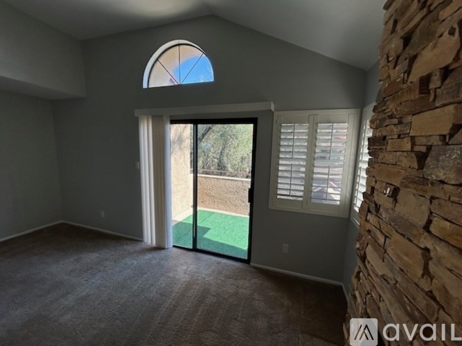 A room with a stone wall and a green mat on the floor.