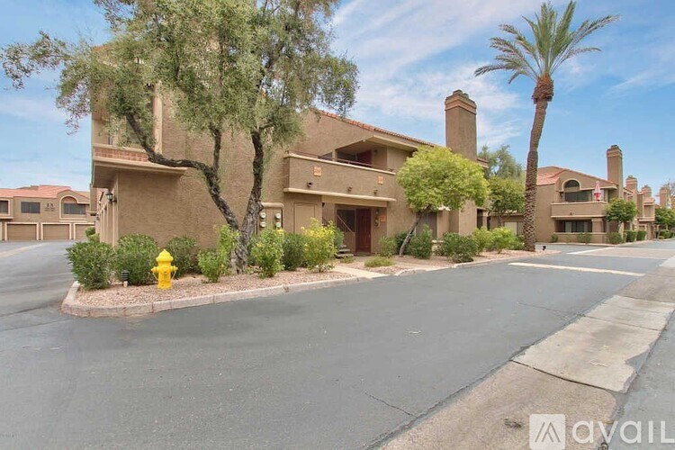 A yellow fire hydrant is in front of a house.