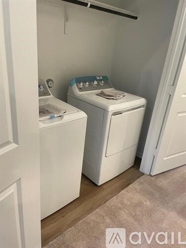 A small laundry room with a washer and dryer.