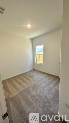 A room with a window and a tiled floor.