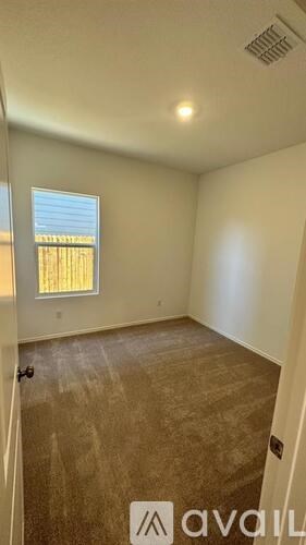 A room with a window and a sign on the wall.