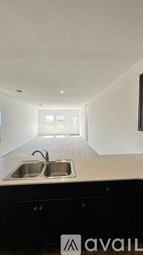 A kitchen with a sink and a window.