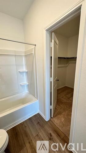 A bathroom with a toilet, sink, and bathtub.