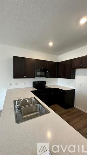 A kitchen with a sink and cabinets.