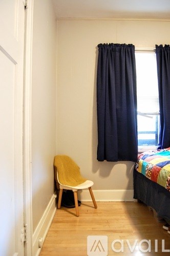 A small room with a bed and a chair.