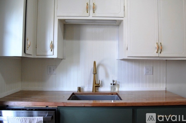 A kitchen with a sink and cabinets.