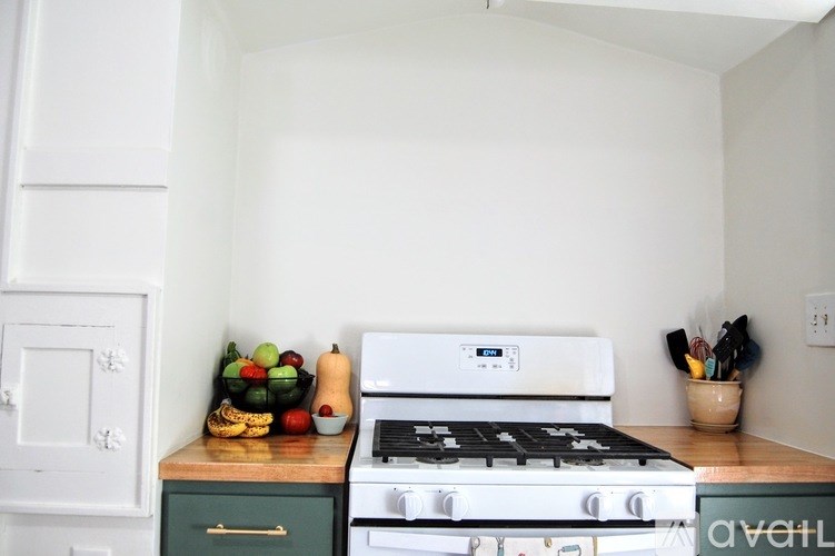 A white stove top oven sits on a countertop in a kitchen.
