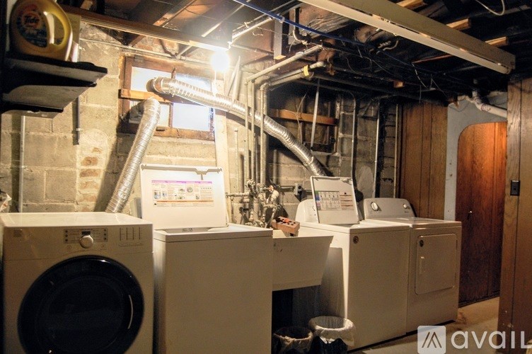 A laundry room with washing machines and a dryer.