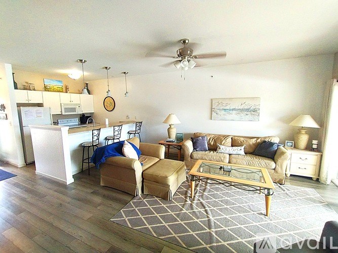 A living room with a couch, chair, and coffee table.