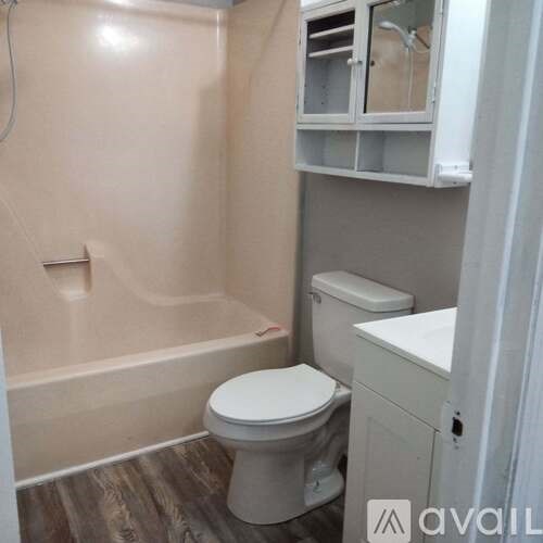 A small bathroom with a toilet, sink, and bathtub.