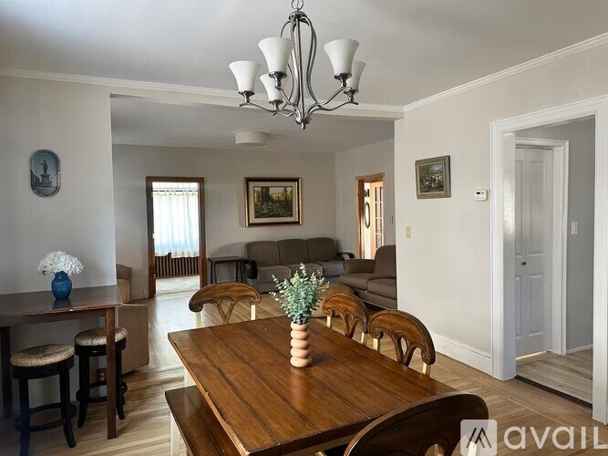 A dining room with a wooden table and chairs.