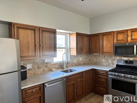 A kitchen with wooden cabinets and a white refrigerator.