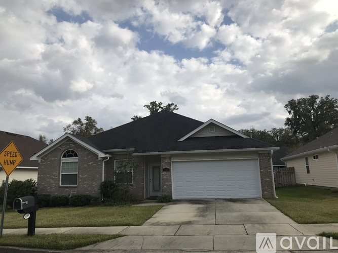 A house with a garage and a sign that says "Speed Home".