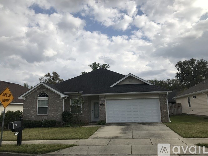 A house with a garage and a sign that says "Speed Home".