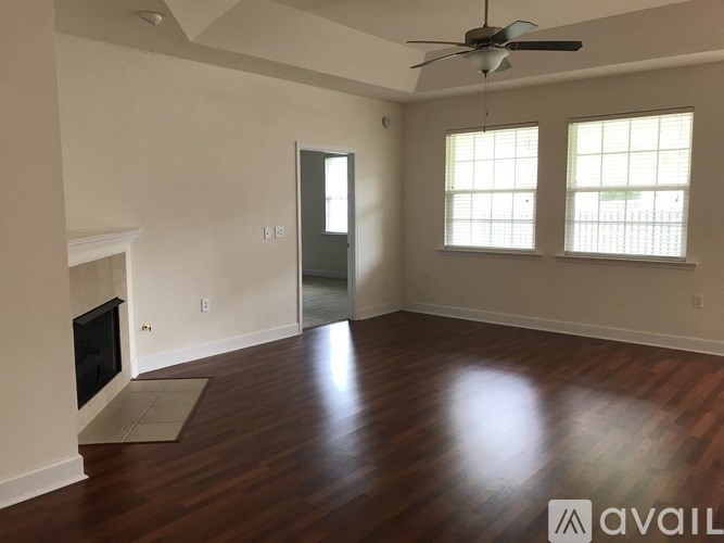 A room with a fireplace and a ceiling fan.
