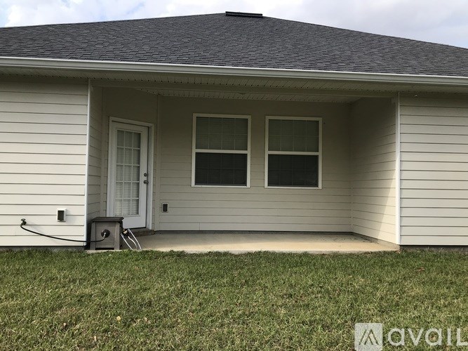 A house with a grey roof and a white door.