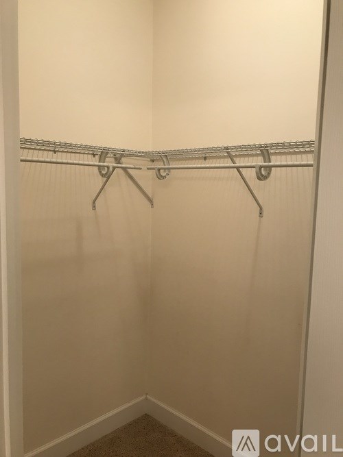 A white closet with a metal rack.