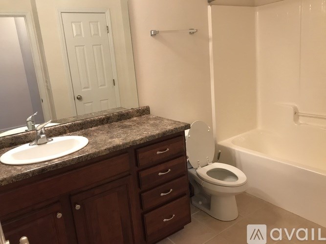 A bathroom with a toilet, sink, and bathtub.