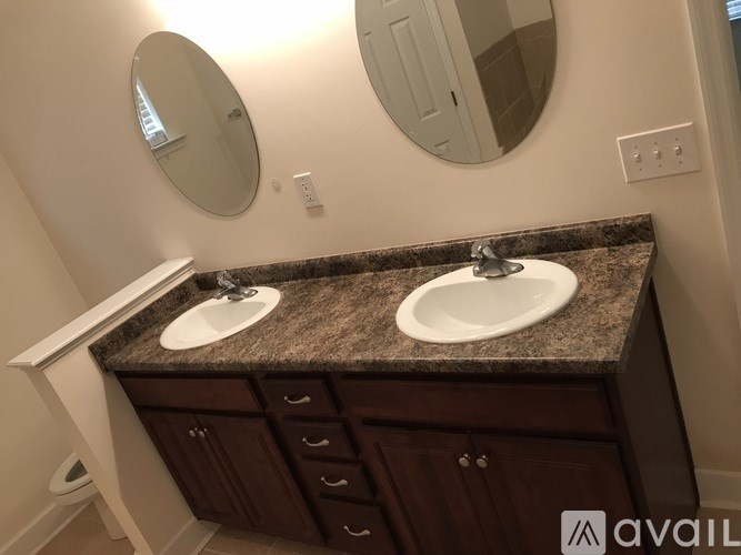 A bathroom with two sinks and a countertop.