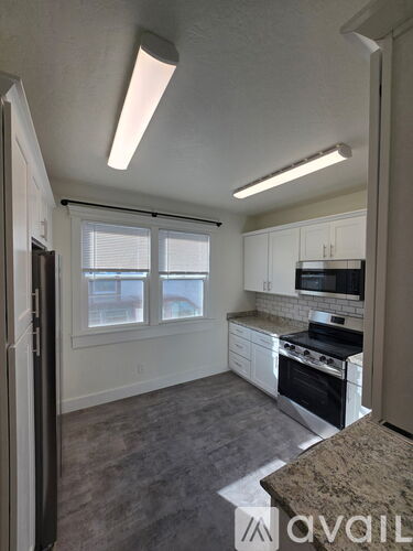 A room with a window and a door is available for rent.