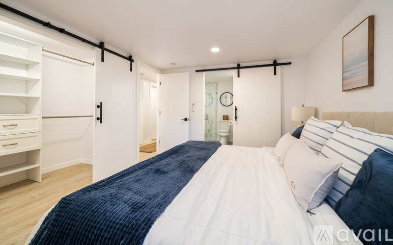 A bedroom with a large bed and a walk-in closet.