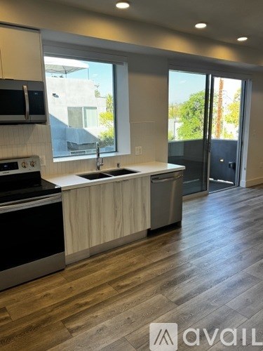 A kitchen with a sink, stove, and oven.