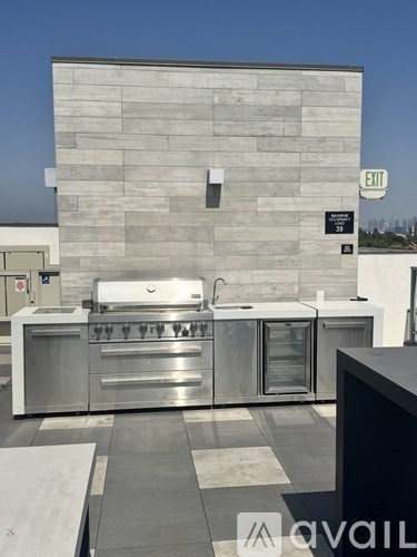 A stainless steel kitchen with a wall of windows.