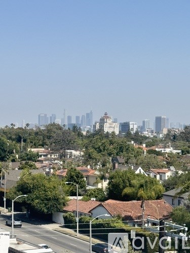 A cityscape with buildings and houses in the foreground.